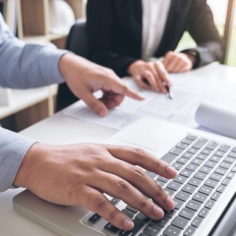 Engineering or Creative architect in construction project, Engin Engineering or Creative architect in construction project, Engineers hands working on construction blueprint and building model at a workplace in office, Building and architecture concept.